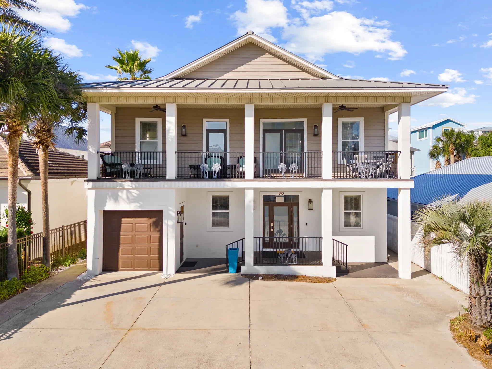 Front of house with balconies and metal roof