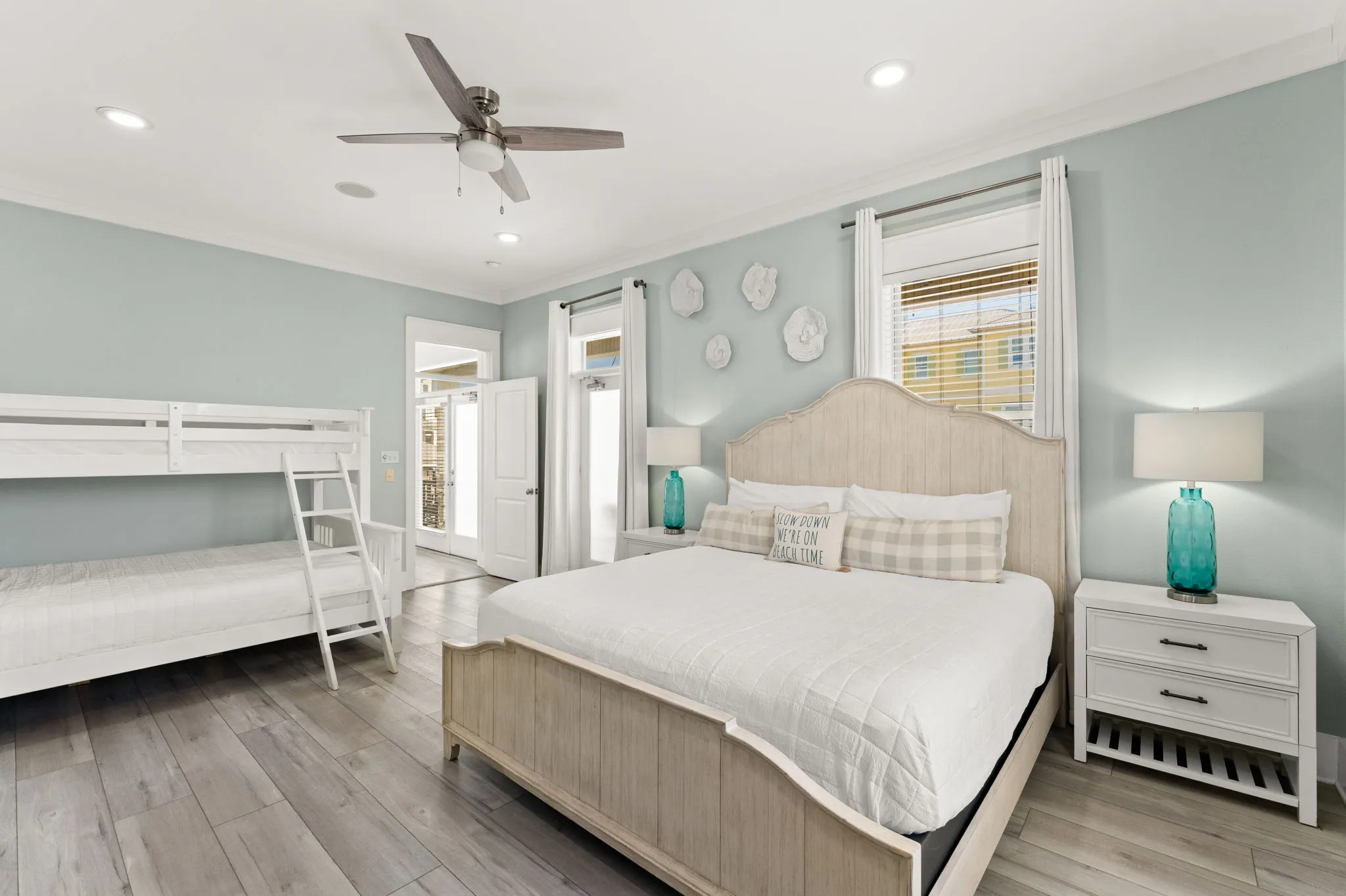 Master bedroom with king bed, built-in bunks, and sage green walls