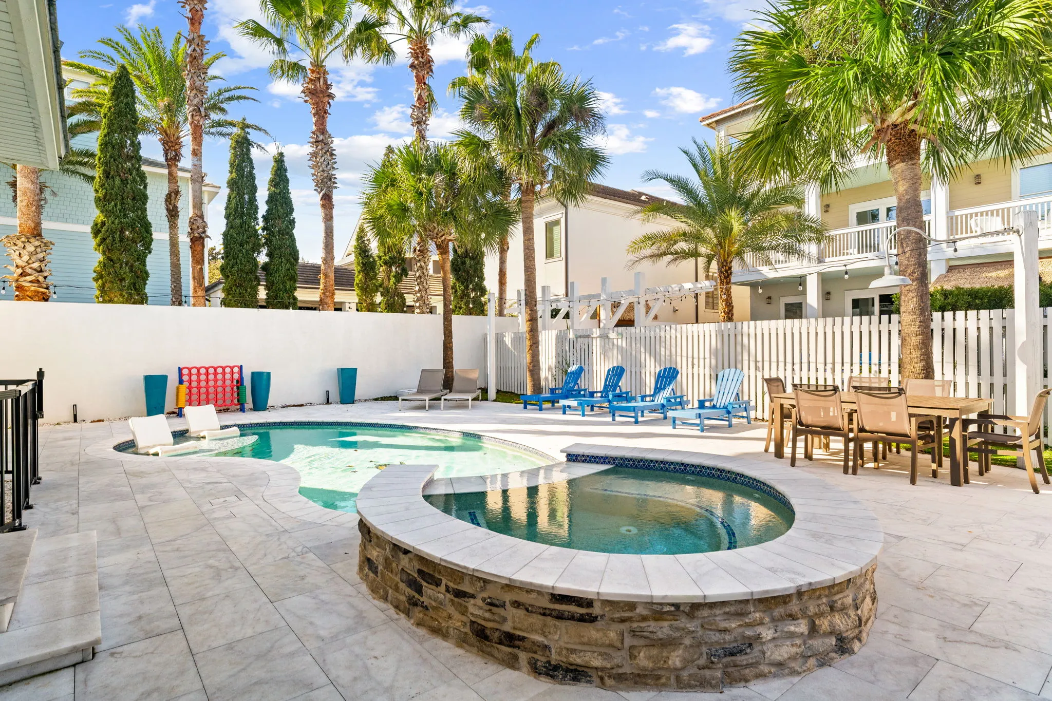 Private heated pool with palms, loungers, and dining - the Sandborne's backyard