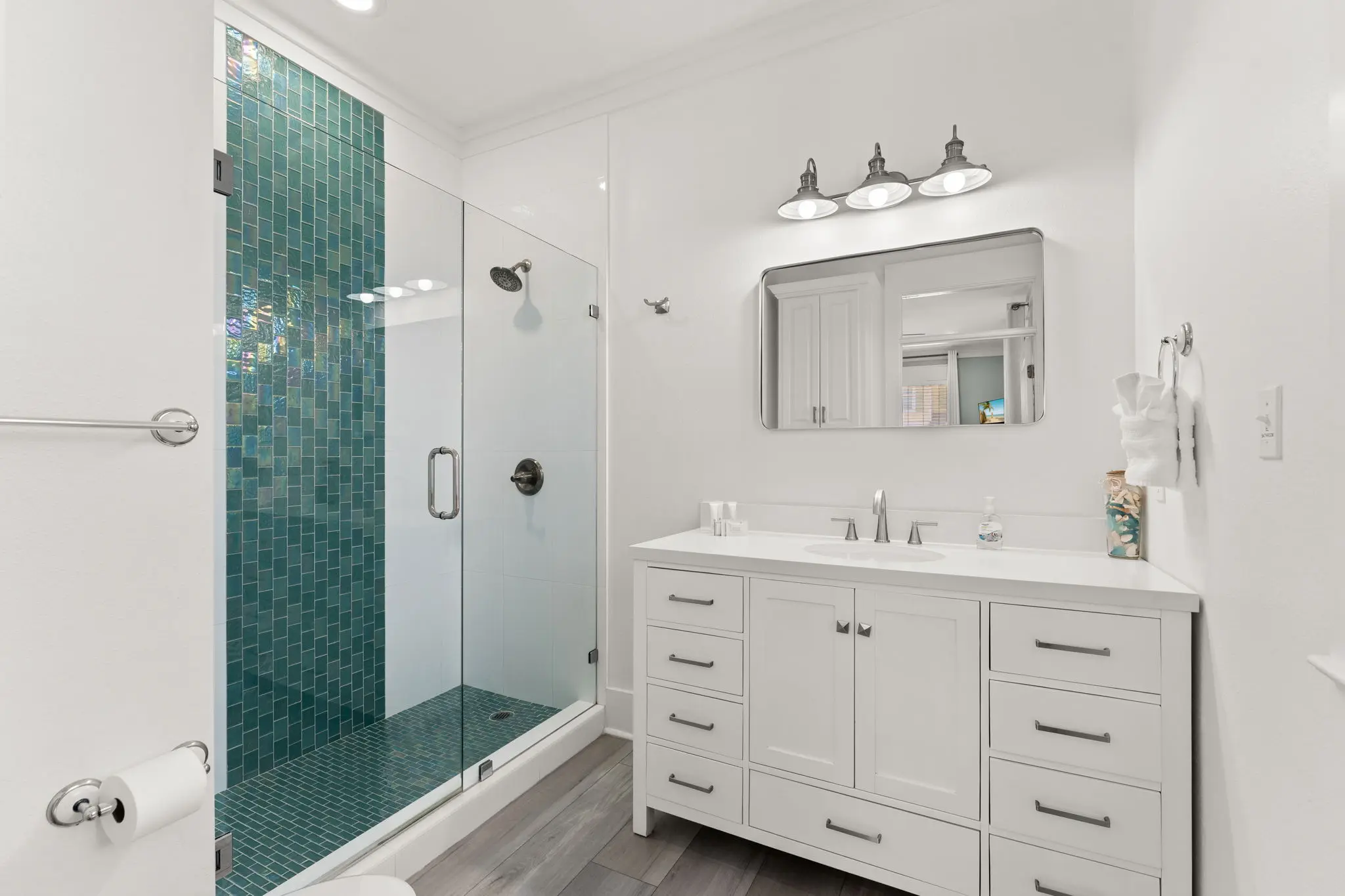 Bathroom with teal glass-tile walk-in shower